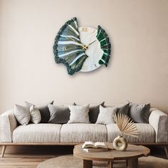 a living room with a couch, coffee table and large clock on the wall above it