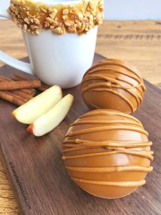 caramel apple slices, cinnamon apples and walnuts on a cutting board next to a cup of coffee