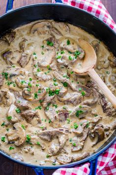 a skillet filled with mushrooms and gravy