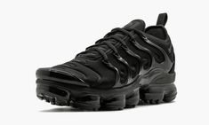 The Nike Air VaporMax Plus "Triple Black" originally released in 2018.  It is a fusion model that combine Nike's futuristic VaporMax cushioning system with the design DNA of the popular Nike Air Max Plus.  A neoprene upper sporting similar details to the 1998 runner is accented by reflective tabs running up the tongue.  A black TPU lacing cage has been added to resemble the represent the overlays on the original Air Max Plus.  Special "Vm Air" logos don each heel and insole as a nod to the yello Triple Black Shoes, Boots Uggs, Nike Air Max Jordan, Buy Nike Shoes, Air Vapormax Plus, Nike Air Vapormax Plus, Nike Vapormax, Air Vapormax, Stadium Goods