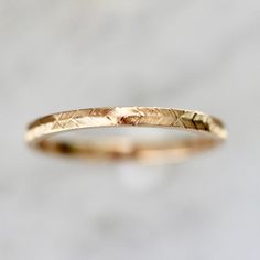 Why I Love It: A modern take on a classic gold band design. Swift and careful hand movements create this wheat engraved texture with precise detail and extraordinary design in your choice of golds. The Details: 14k Yellow Gold, 14k White Gold, 14k Rose Gold, 18k Peach Gold® Band Width is Approx. 1.80 mm Band Height is Approx. 1.30 mm Made to order in your size, please allow approximately 4 to 6 weeks for delivery Bands are all hand engraved and may come with subtle variations left by the artist 1.5mm Wedding Band, Carved Wedding Bands For Women, Delicate Gold Engraved Ring For Wedding, Delicate Yellow Gold Engraved Wedding Ring, Engraved Yellow Gold Band Ring, Simple Gold Wedding Band Engraved, Yellow Gold Brass Engraved Wedding Ring, Midi Rings Gold, Handmade Gold Ring