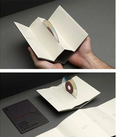 an open book with a cd in the middle and another opened book on the other side