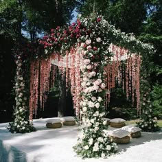 an outdoor wedding setup with flowers and rocks