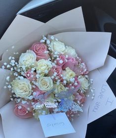 a bouquet of roses and baby's breath sits in the passenger seat of a car