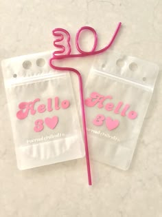 there are two plastic bags with pink numbers on them