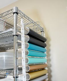 a metal shelf filled with lots of different colored sheets