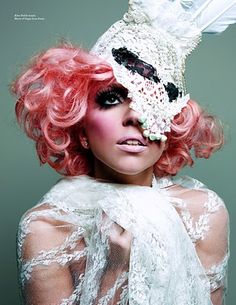 a woman with pink hair wearing a mask