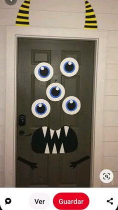 a door decorated to look like a monster with big blue eyes and yellow striped headbands