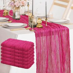 the table is set with pink napkins and place settings