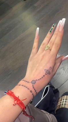 a woman's hand with some tattoos on it