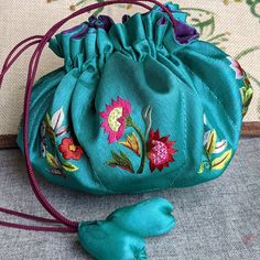 Style: handmade drawstring silk bag embroidered with flowers, eight compartments for jewelry storage, exceptional workmanship Material: silk Method: Embroider on silk Type: drawstring silk bag Size: H4", diameter 8" Green Bags With Floral Embroidery As A Gift, Festival Embroidered Green Potli Bag, Gift Floral Embroidered Potli Pouch Bag, Traditional Green Pouch Potli Bag, Traditional Green Potli Pouch Bag, Green Traditional Bag With Floral Embroidery, Bead Bar, Silk Bag, Flowers Handmade