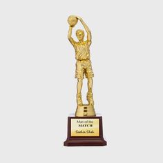 a gold trophy with a basketball player holding a ball in it's hand and the words maker of the match written on it