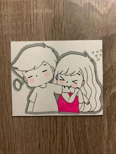 a drawing of two people kissing each other on a piece of paper that has been cut out