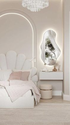 a white bed sitting in a bedroom next to a mirror