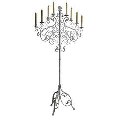 an iron candelabra with eight candles on it's stand, isolated against a white background