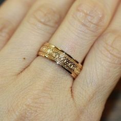 a woman's hand with a gold ring on it