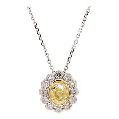 RareGemWorld's classic diamond pendant. Mounted in a beautiful 18K Yellow and White Gold setting with a natural oval cut yellow diamond. The yellow diamond is surrounded by natural round white diamond melee. This pendant is guaranteed to impress and enhance your personal collection! Total Weight: 1.07cts Natural Oval Yellow Diamond Natural Round White Diamonds 18K Yellow/White Gold All diamonds are guaranteed natural International Shipments: Please note that customers are responsible for all import duties and taxes applicable to the country of shipment Returns: Returns accepted in original format within 14 days of receipt Do not forget to view our entire inventory! Thank you for reviewing our item White Gold Set, Yellow Diamond, Drop Pendant, Drop Necklace, Oval Diamond, Diamond Pendant, White Diamond, Oval Cut, Diamond White