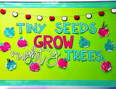 a sign that says tiny seeds grow mighty trees on the side of a green wall