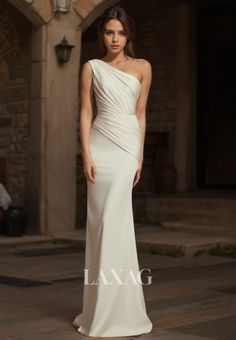 a woman in a white dress standing on a stone floor with her hand on her hip