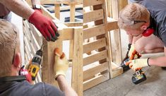 two men are working on some construction project together, while another man is holding a drill