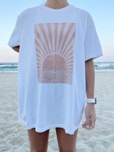 "The PERFECT summer graphic tee! Comfort Colors white t-shirt with a sun design. Model is 5'4\" and wearing a size XL for an oversized look. 100% cotton." Sun Graphic, Summer Graphic Tee, Sun Design, White Comforter, Sun Designs, Comfort Colors Tee, Star Shirt, Womens Clothing Sizes, Design Model