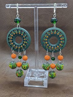 Beautiful hand painted wooden earrings with glass beads. Really fun and colorful to wear. Bohemian Multicolor Wooden Bead Earrings, Green Handmade Fun Earrings, Multicolor Wooden Beads Dangle Earrings, Multicolor Wooden Beaded Earrings As A Gift, Handmade Green Beaded Earrings, Multicolor Dangle Beaded Earrings With Wooden Beads, Green Beaded Fun Earrings, Green Hand-painted Bohemian Earrings, Fun Green Beaded Earrings