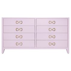 a pink dresser with gold handles on it