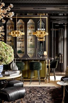 a living room filled with furniture and a chandelier above a dining room table