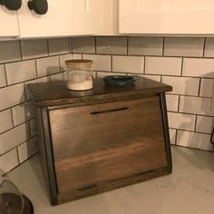 a kitchen with white cabinets and black counter tops, including an old fashioned stove top