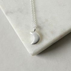 This necklace features the sweetest little crescent moon charm on dainty but sturdy sterling silver cable chain. The charm is about 13mm long (including the loop) and about 7mm wide. A perfect everyday necklace! It is fastened with a sterling spring ring clasp and you can choose your desired length from the drop-down menu above. You can find more celestial jewelry here: www.etsy.com/ca/shop/juliegarland/search?search_query=celestial+jewelry Minimalist Crescent Moon Phase Charm Necklace, Sterling Silver Half Moon Charm Necklace, Minimalist Silver Moon Charm Necklaces, Dainty Half Moon Sterling Silver Charm Necklace, Dainty Sterling Silver Half Moon Charm Necklace, Sterling Silver Crescent Moon Charm Necklace, Everyday Moon Shape Sterling Silver Charm Necklace, Everyday Moon Shaped Sterling Silver Charm Necklace, Everyday Sterling Silver Moon Charm Necklace