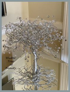 a silver tree with lots of beads on it