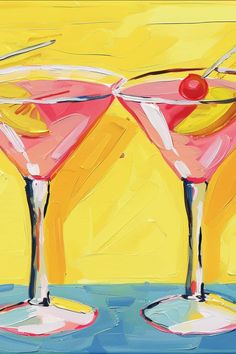 two pink martinis with cherries on the rim