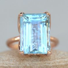 an aqua blue topazte ring on a rock