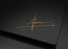 a black laptop with gold lettering on it