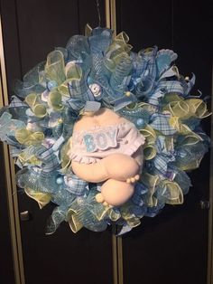 a blue wreath with a teddy bear on it's side and the word boy written on it