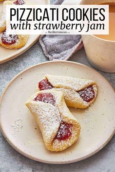 two pastries with powdered sugar on them and a cup of tea