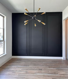 a large chandelier hangs from the ceiling in an empty room