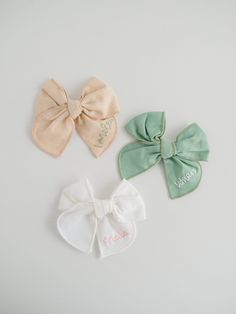 We love these custom hand-embroidered name hair bows! Bows are fable style and available in seven different colors with each name hand-embroidered onto the right side of the bow. These make perfect gifts for the little loves in your life! ---- DETAILS: - This listing is for one name bow with an alligator clip. Each item is made-to-order. - Names are hand-embroidered on each bow, seven letter max. - Bows are approximately 3.5 inches HOW TO ORDER: 1 - Pick bow & thread colors 2 - Name (case sensit Cute White Cotton Hair Accessories, White Cotton Hair Accessories For Gifts, White Cotton Hair Accessories For Gift, White Cotton Hair Accessories As Gift, Cute Cotton Bow Hair Accessories, Cute Cotton Hair Accessories For Gifts, Cotton Bow Hair Accessories For Gifts, Cotton Bow Hair Accessories For Gift, Embroidery Bow