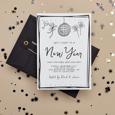 a new year's eve party card with confetti and black envelopes