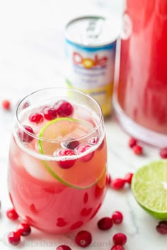 a drink with pomegranate and lime on the side