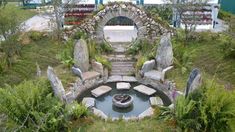 an aerial view of a small garden with a fountain