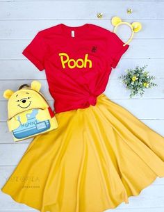 a winnie the pooh costume with a book and headband on top of it