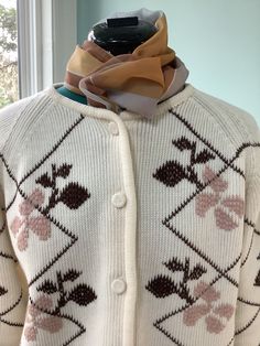 Thick Acrylic 60's -70's Sweater  Crew neck Button front with Raglan sleeves  Leafy design on front in colors of beige and dark chocolate brown  Yarn covered buttons  Boxy fit  Size 12-14 Shoulders- 16 1/2" Sleeves -23" 24" Bust -44" Waist -46" Length - 22 1/2" Beautiful vintage condition,pre owned Fitted Button-up Retro Cardigan, Retro Fitted Button-up Cardigan, Retro Fitted Sweater With Button Closure, Vintage Beige Button-up Sweater, Retro Button-up Cardigan, Retro Cream Cardigan For Fall, Fitted Brown Retro Cardigan, White Retro Sweater With Buttons, Retro White Sweater With Buttons