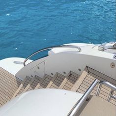 the stairs lead down to the deck of a boat that is in the water and blue