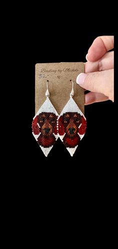 a pair of red and white beaded earrings