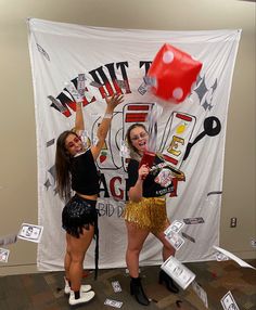 two women are posing in front of a sign