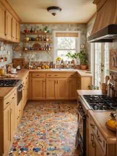 a kitchen filled with lots of wooden cabinets and counter top space next to a window