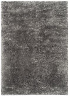 an area rug with grey fur on it