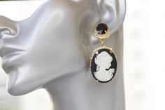 BLACK And White CAMEO EARRINGS, Statement Cameo Earrings, Victorian Vintage Bridal Earrings, Chandelier Evening Earrings, Earrings Details of item: Metal: 24K Gold Plated ( rose or yellow ) or silver plated - Nickel Free Gemstone: crystal and acrylic cameo Earrings Size: 2*0.9 inches The earrings will be packed in a gift box. Ready to ship 1-3 days, FOR MY EARRINGS COLLECTION HERE: https://www.etsy.com/il-en/shop/rebekajewelry?section_id=14222612&ref=shopsection_leftnav_3 TO GET TO MY ETSY S Elegant Cameo Drop Earrings, Elegant Cameo Clip-on Earrings Gift, Elegant Cameo Earrings For Wedding, Elegant Round Cameo Earrings, Cameo Drop Earrings For Wedding, Elegant Cameo Dangle Earrings, Elegant Handmade Black Clip-on Earrings, Elegant Evening Jewelry With Cameo Detail, Elegant Black Bridal Earrings As Gift