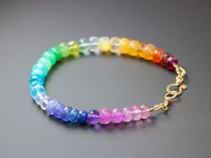 Vibrant rainbow gemstone bracelet, made in 14K Solid Gold, with gorgeous fine gemstones. Here I have gathered the most stunning, clear, sparkling AAA quality rondelles faceted and smooth. The precious rondelles I used are large and of extremely high quality – just look how each one glows and sparkles! Their size is between 6mm to [...] Rainbow Gemstone Beads Bracelets For Jewelry Making, Rainbow Multi-stone Bracelets As A Gift, Elegant Rainbow Bracelets With Round Beads, Elegant Rainbow Beaded Bracelets, Elegant Rainbow Round Beads Bracelet, Rainbow Multi-stone Bracelet Jewelry, Rainbow Multi-stone Bracelet, Rainbow Gemstone Beads Bracelet, Rainbow Bracelet For Jewelry Making